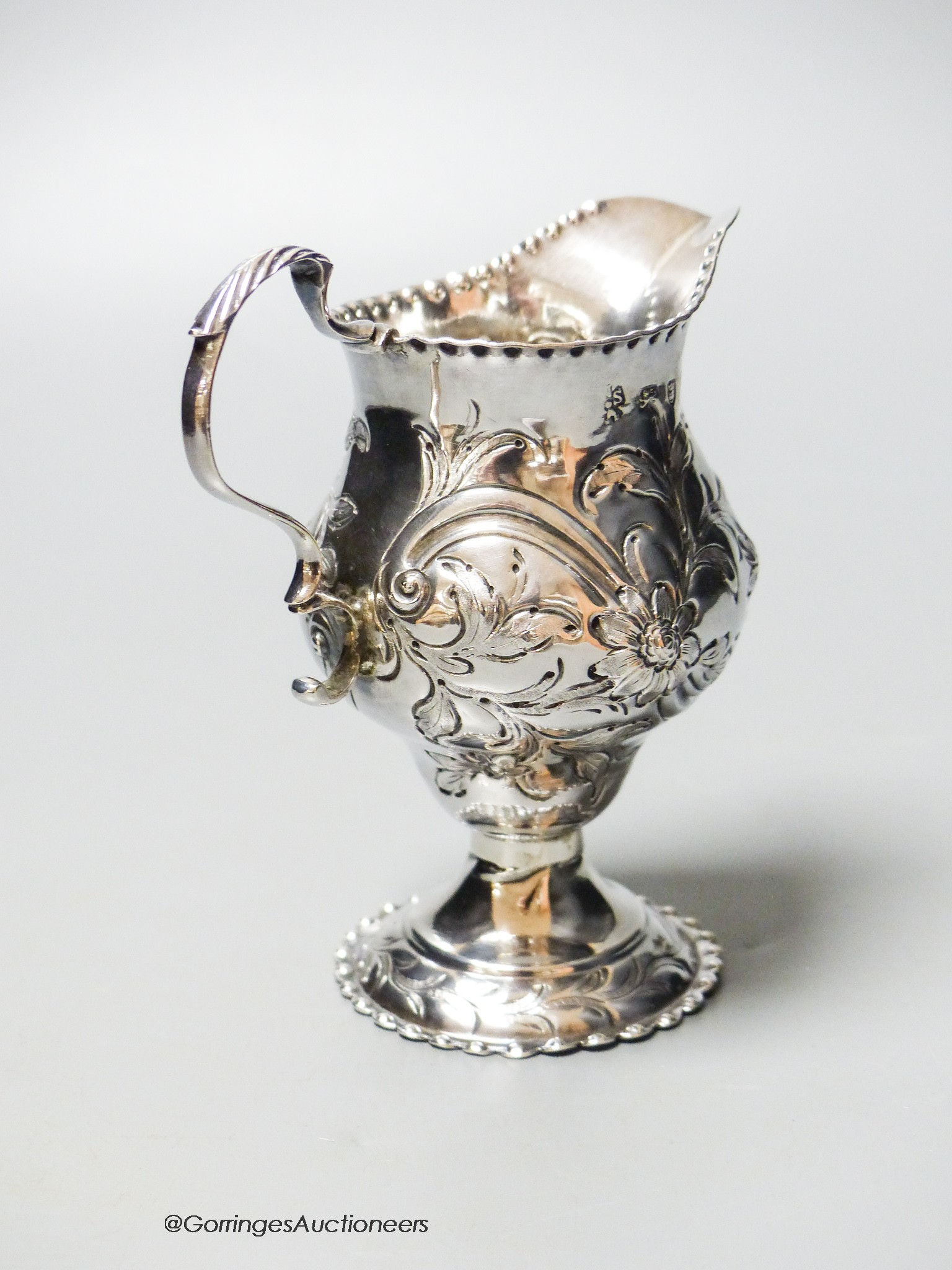 A George III silver helmet cream jug, with later embossed decoration, London, 1778, 10.6cm, 83 grams.